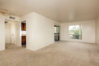 living room with beige carpet and sliding doors to balcony at Bridge Lane
