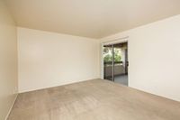 living room with beige carpet and sliding doors to balcony at Bridge Lane
