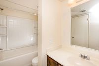 full bath with shower tub combo and white vanity at Bridge Lane