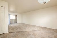 living room with beige carpet and sliding doors to balcony at Bridge Lane