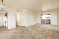 partial view of kitchen and living room with brown carpet at Bridge Lane
