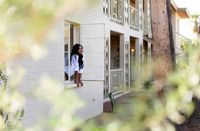 woman looking out of apartment home window at oasis 20