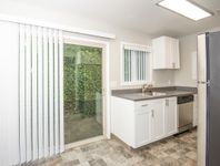 kitchen with stainless steel appliances, tile flooring, and patio door