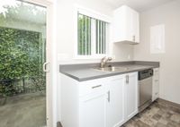 kitchen with stainless steel appliances, tile flooring, and patio door