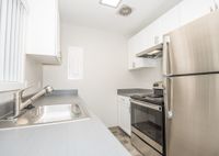 kitchen with stainless steel appliances, tile flooring, and patio door