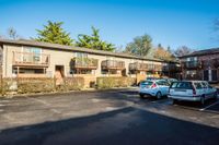 large parking lot with lush landscaping