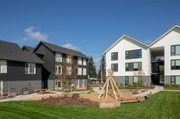 kids play area with wooden balance beams and wooden teepee at twelve mile crossing
