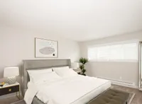 rendering of bedroom with bed and side tables and brown carpet at 81 powell apartments