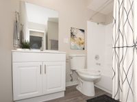 full bath with tub and vinyl wood like flooring at 81 powell apartments