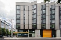Studios in Downtown Portland OR - ORO - An exterior shot of The Apartment Building with Black, Yellow, and Grey Details and Many Windows
