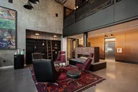 fireplace with modern suede lounge chairs and round coffe tale at the lounge at oro apartments