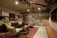 lounge area with leather sofa and arm chairs at oro apartments