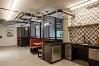 the mezz-semi private booths and sitting area with kitchen at oro apartments