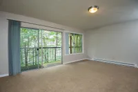 large living space with private patio that opens up to trees