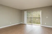 large living space with wood floors and private patio