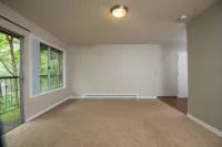 large living space with private patio that opens up to trees