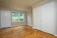 livingroom with wood flooring and large closets