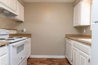 Kitchen with White Cabinets & Brown Counters