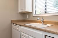 Kitchen with White Cabinets & Brown Counters