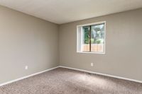 Large Bedroom with Window and Carpet