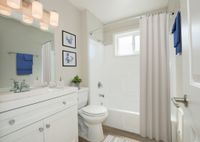 Spacious bathroom with white cabinets and soaking tub