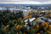 The Fredrick Aerial Exterior photos during fall landscape tucked away in the trees. View of Portland, Oregon skyline