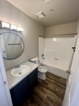 full bath with shower-tub combo and black vanity at Monterey Apartments