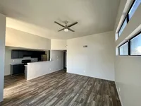 living room with vinyl wood like flooring and ceiling fan at Monterey Apartments