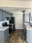 kitchen with stove, fridge, and appliances and vinyl wood like flooring at Monterey Apartments