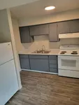 kitchen with stove, fridge, and appliances and vinyl wood like flooring at Monterey Apartments