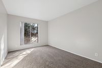 Bedroom with carpet and plastered walls