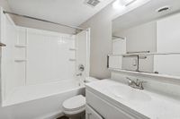 Bathroom with view of shower, bath, toilet, and sink