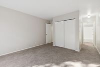 Bedroom with closed closets and carpets