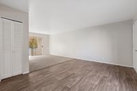 Living area with wooded floors and carpet and patio