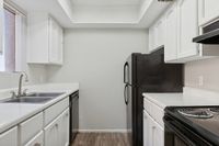 Kitchen with sink, refrigerator, oven, and cupboards