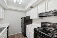 Kitchen with sink, refrigerator, oven, and cupboards