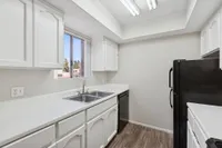 Kitchen with sink, refrigerator, oven, and cupboards