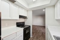 Kitchen with oven, wooden floors, and cupboards