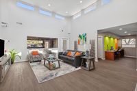 Community area with seating, TV, business section, high ceilings and windows