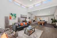 Games room and community area with pool table and seating along with high ceilings and windows