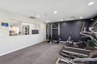 Fitness center with mirror, treadmill, elliptical, cable gym, and exercise bike