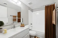 Virtually staged bathroom with shower curtain, towel, soap