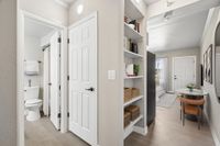 Virtually staged studio at Solaris at Tucson showing the hallway into the bathroom