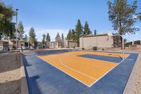 Full-view of the outdoor basketball court with a mountain backdrop.