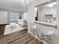 Seamless blend of dining and lounging Memorial Fountain Apartment Kitchen and Living Room | Apartments in Houston, TX