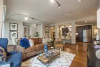 Seamless flow between the cozy living space and modern kitchen Pearl Residences at City Centre Apartment Living Room and Kitchen | Houston, TX Apartments | Houston CityCentre Apartments