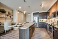 Combined kitchen and dining space for comfort. The McCarthy at Memorial City Kitchen Island | Houston, TX Apartments | Apartments in Houston, TX