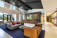 Spacious, contemporary lobby with stylish seating, modern artwork, and high ceilings.