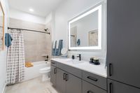 houston apartments | apartments near memorial city | apartments zoned to Katy ISD | apartments near hwy6 |Contemporary bathroom design featuring a sleek vanity with illuminated mirror, modern fixtures, and elegant neutral tones.