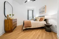 houston apartments | apartments near memorial city | apartments zoned to Katy ISD | apartments near hwy6 |Inviting bedroom with modern decor, featuring a cozy bed with plush pillows, elegant wooden dresser, and stylish lighting for a serene ambiance.